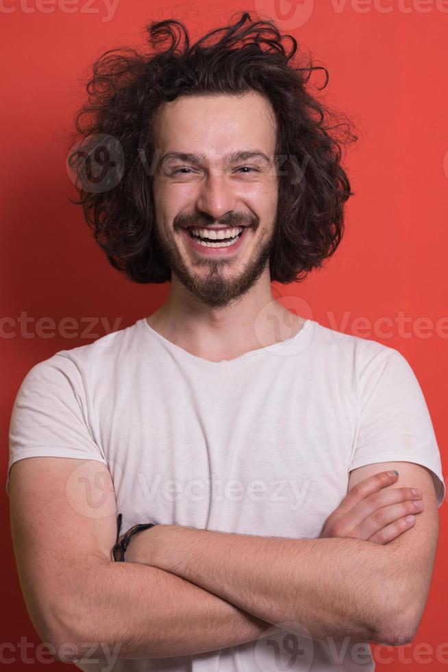 young man with funny hair over color background photo