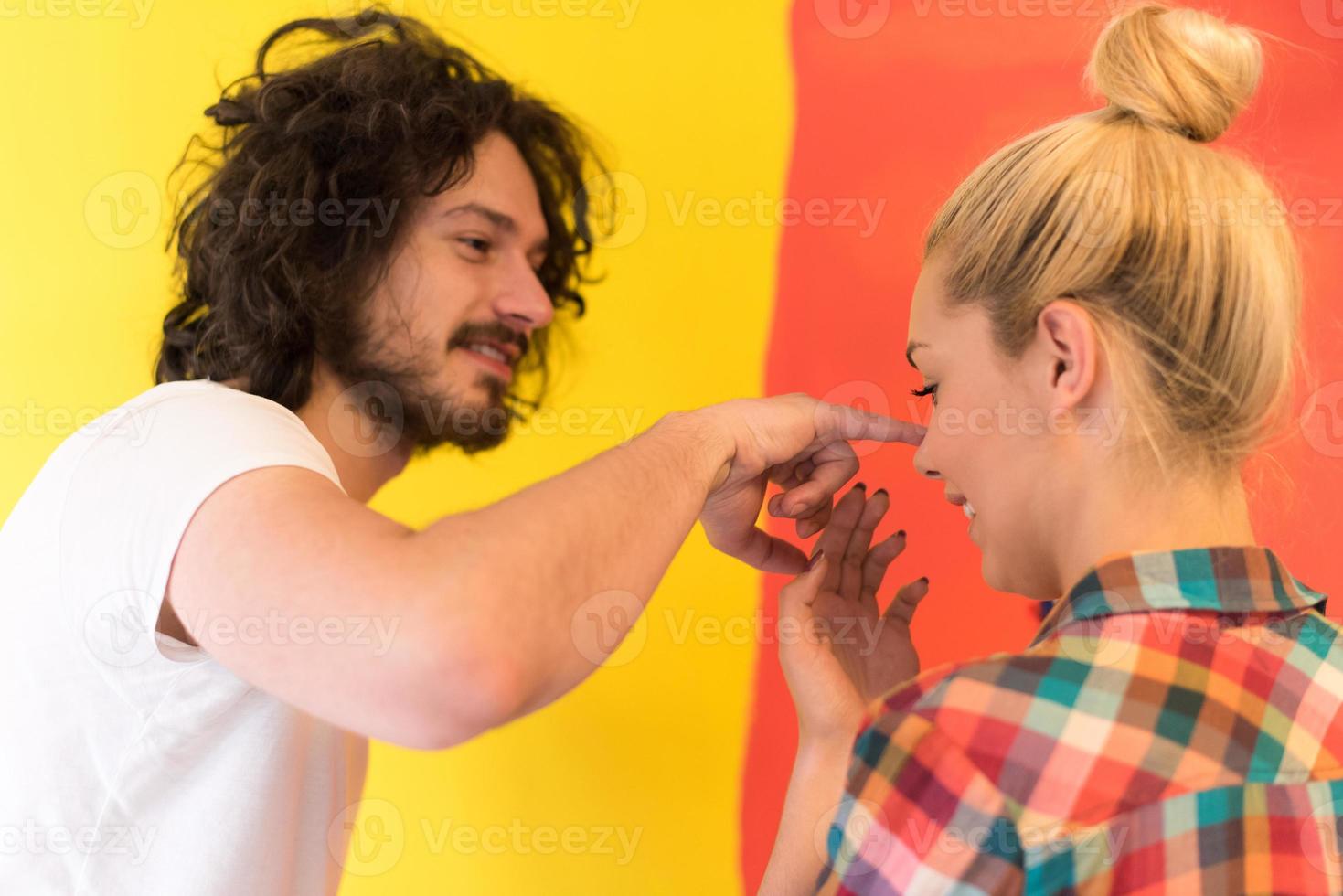 couple painting interior wall photo