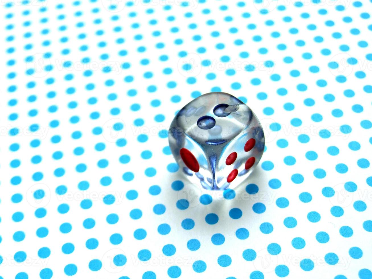 gamblig dice on blue dotted background photo