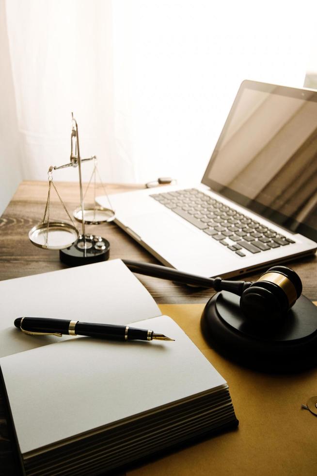 Business and lawyers discussing contract papers with brass scale on desk in office. Law, legal services, advice, justice and law concept picture with film grain effect photo