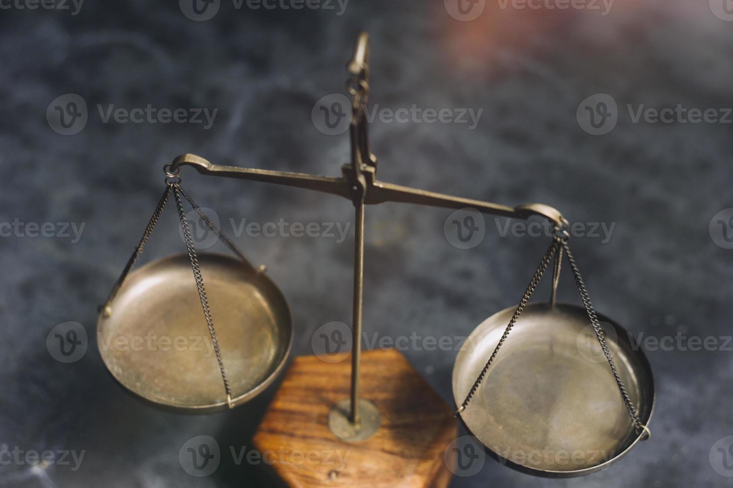 Business and lawyers discussing contract papers with brass scale on desk in office. Law, legal services, advice, justice and law concept picture with film grain effect photo