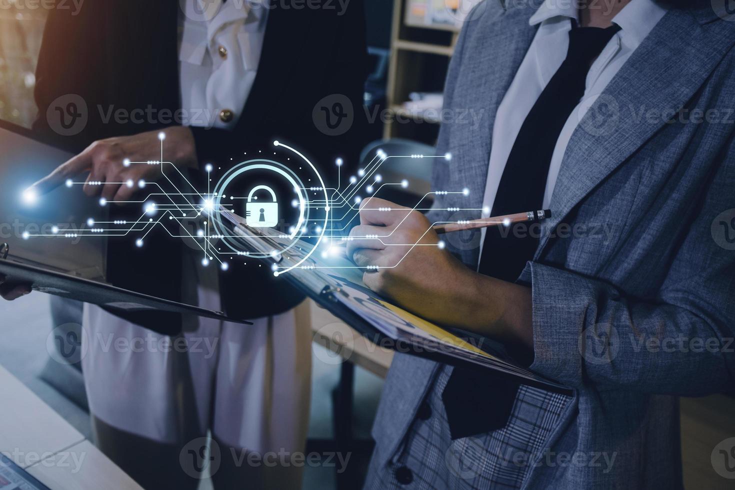 Cybersecurity and privacy concepts to protect data. Lock icon and internet network security technology. Businessman protecting personal data on smart phone with virtual screen interfaces. photo