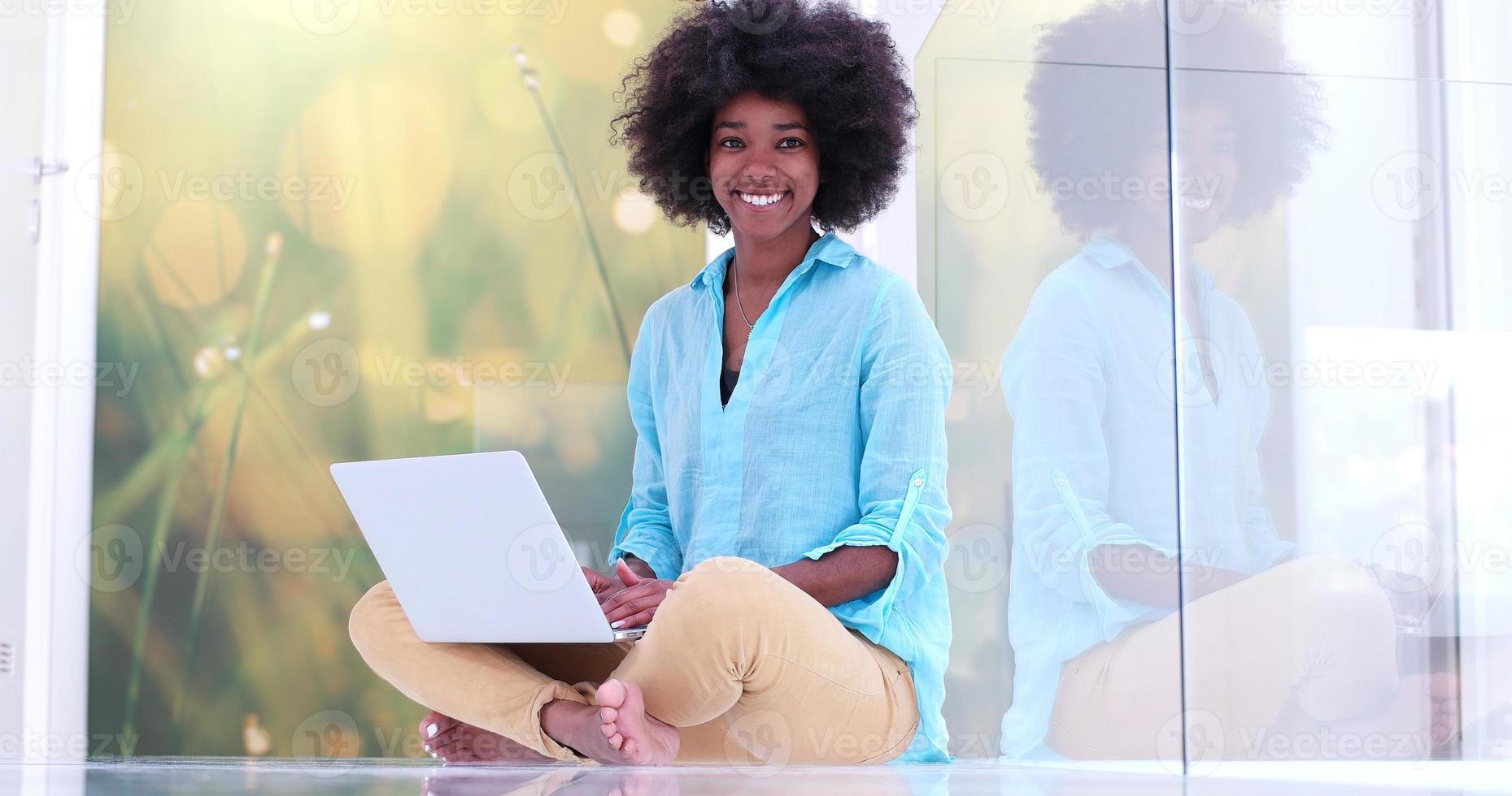 black women using laptop computer on the floor photo