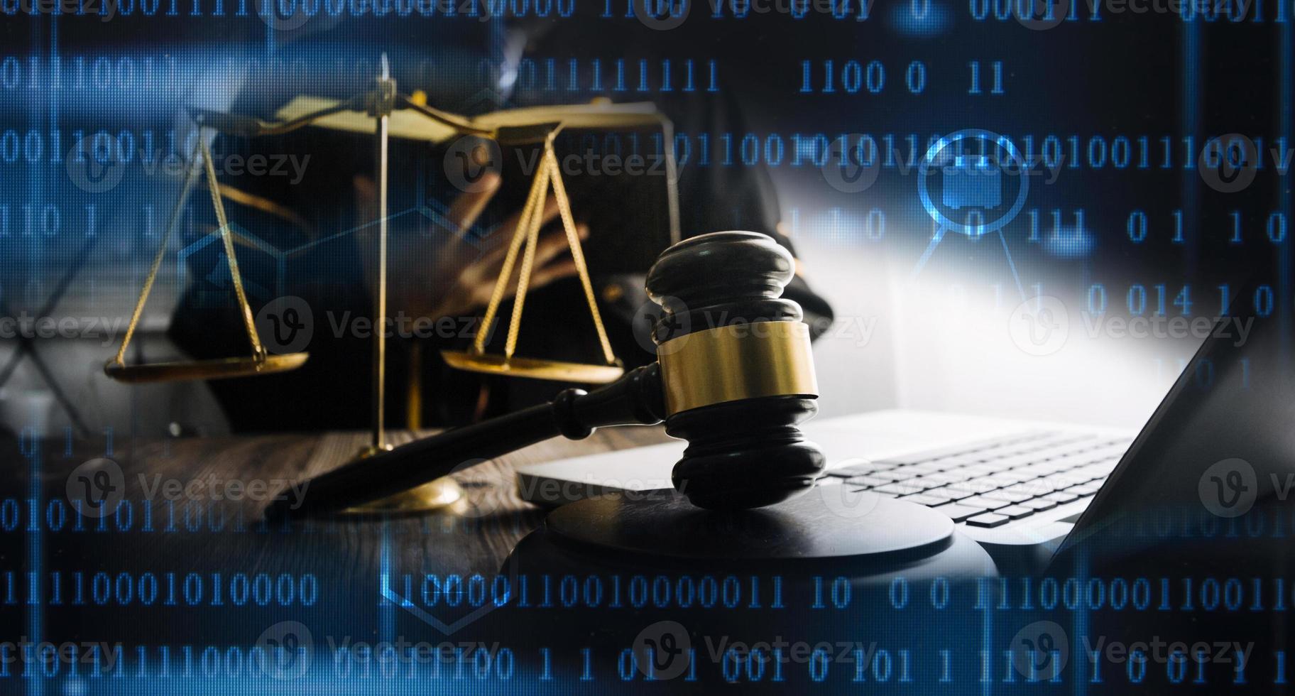 Justice and law concept.Male judge in a courtroom with the gavel, working with, computer and docking keyboard, eyeglasses, on table in morning light photo