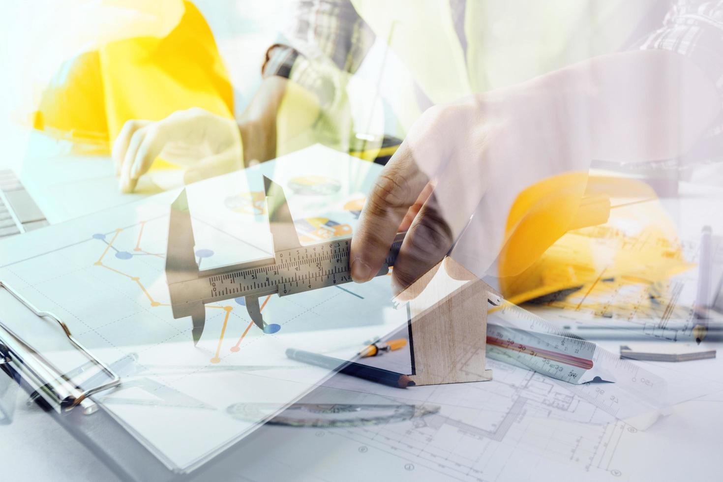 business hand working and laptop with on on architectural project at construction site at office desk in office photo