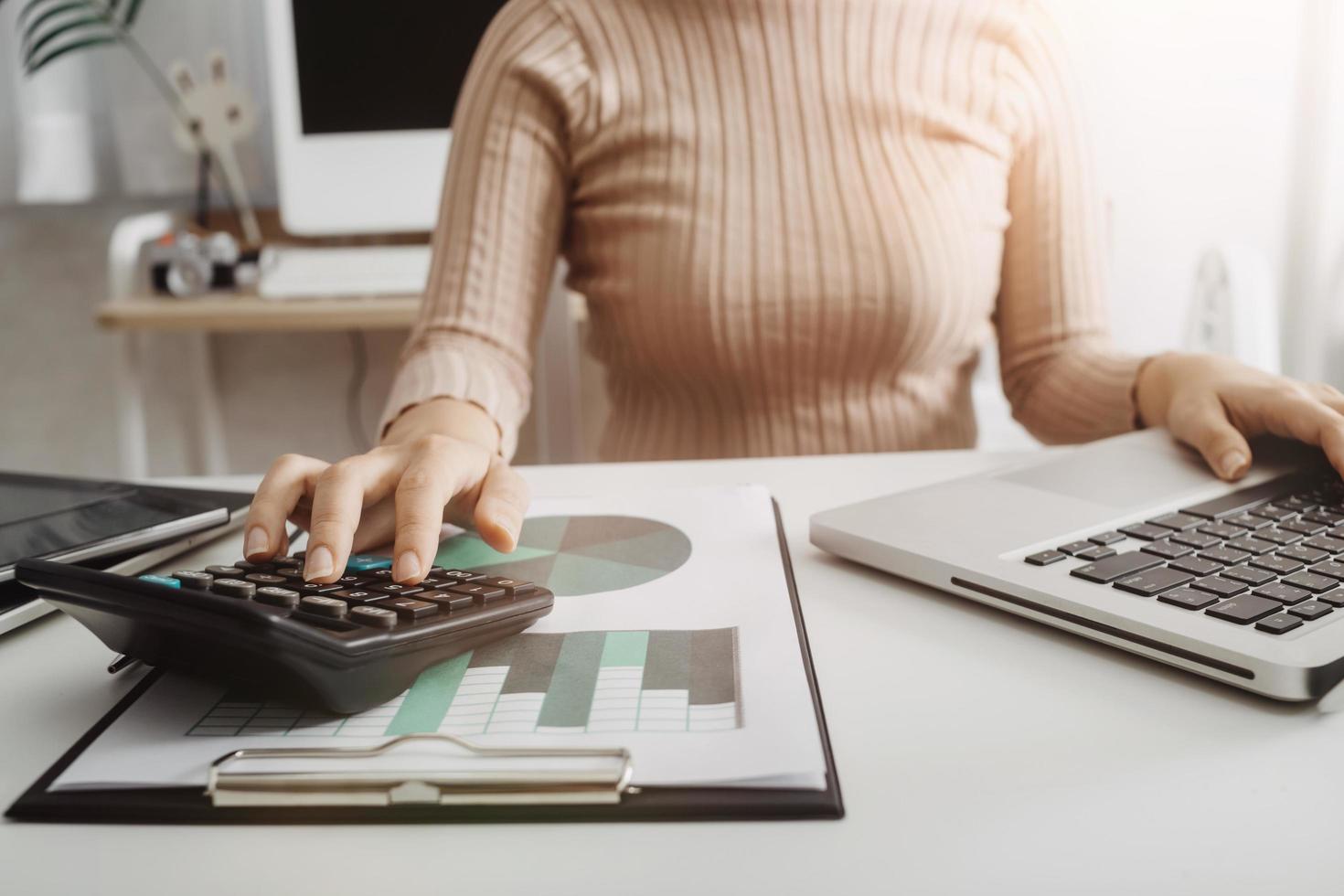 Business accounting concept, Business man using calculator with computer laptop, budget and loan paper in office. photo