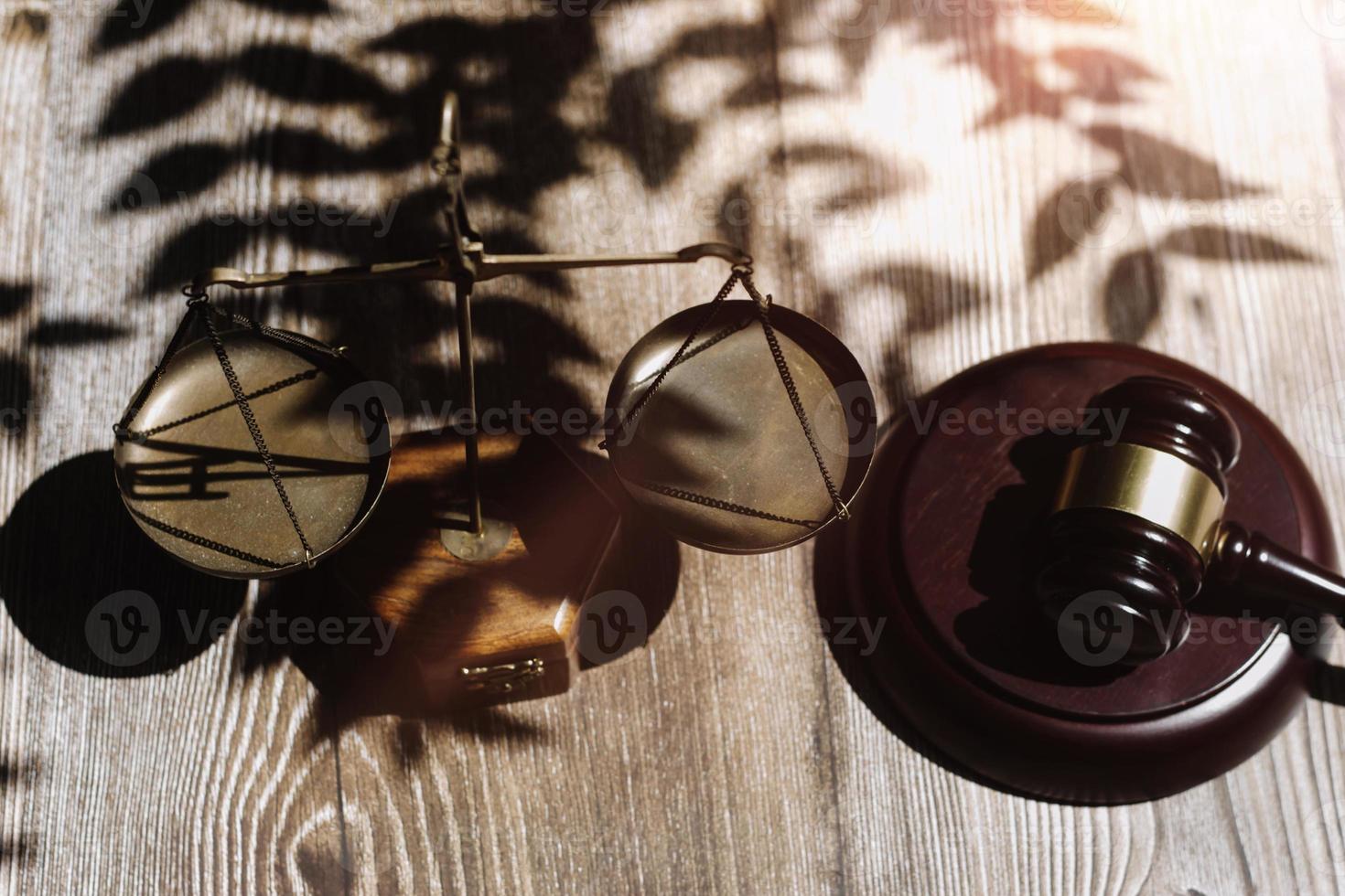 Business and lawyers discussing contract papers with brass scale on desk in office. Law, legal services, advice, justice and law concept picture with film grain effect photo