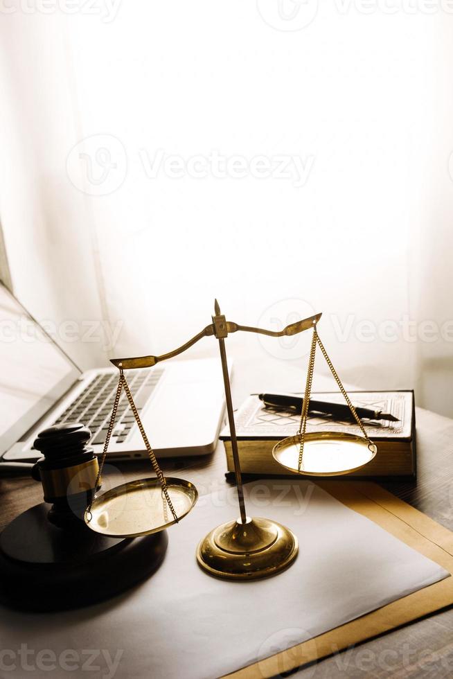 Business and lawyers discussing contract papers with brass scale on desk in office. Law, legal services, advice, justice and law concept picture with film grain effect photo