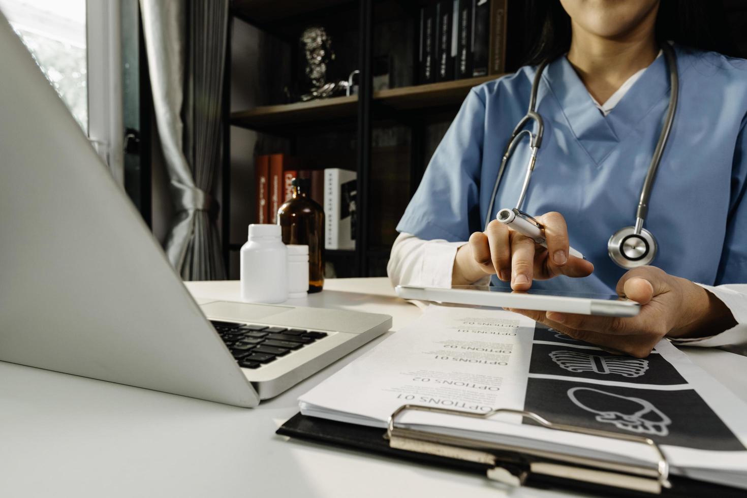 Medicine doctor and stethoscope touching icon medical network connection with modern interface on digital tablet in hospital background. Medical technology network concept photo