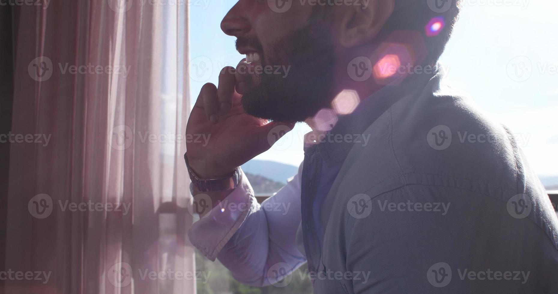 Business Man Talking On Cell Phone At Home photo