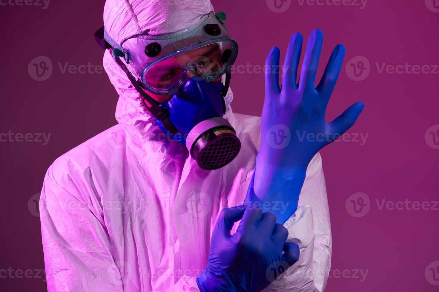 Doctor wearing protective biological suit and mask due to coronavirus photo