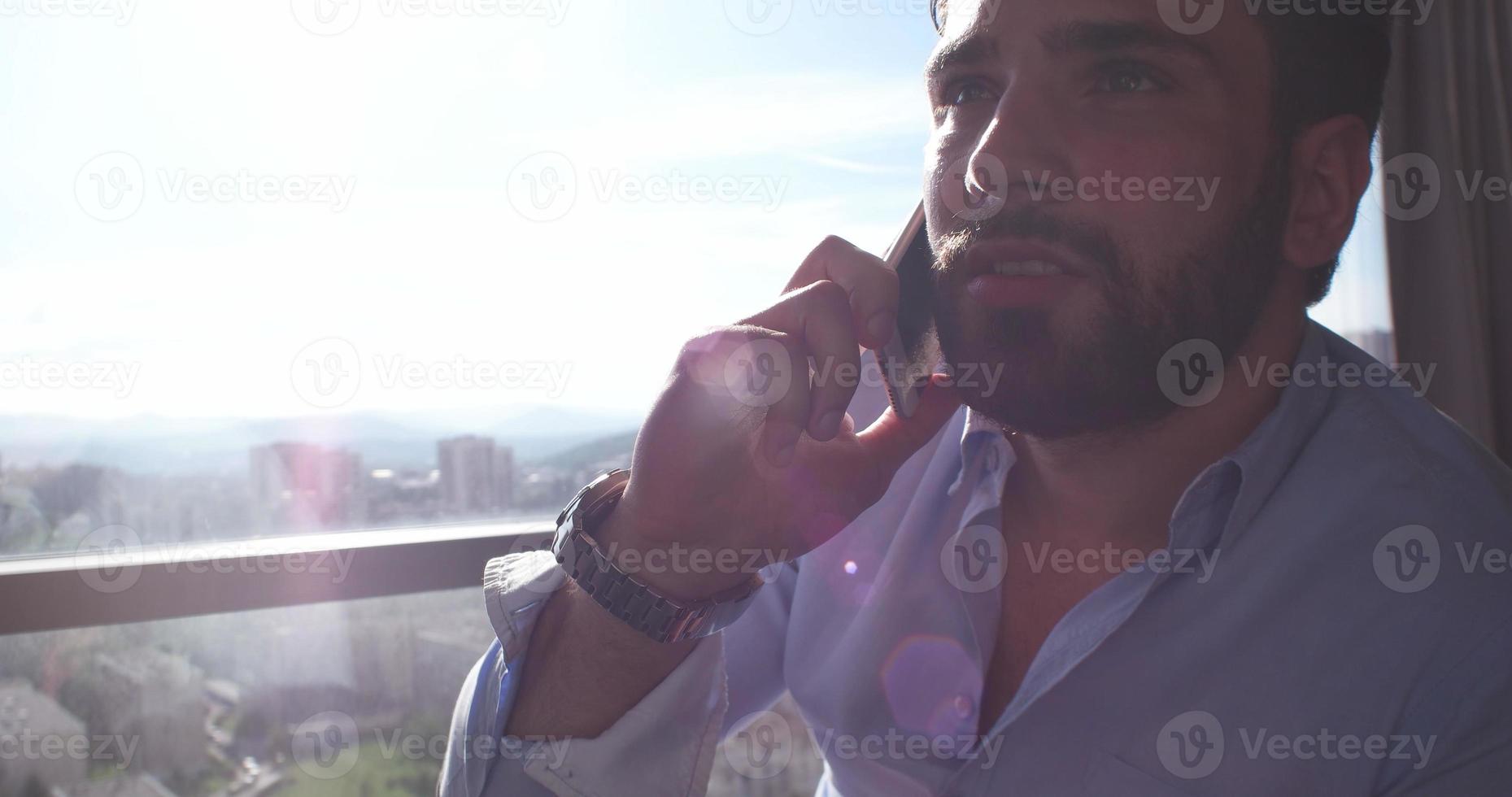 Business Man Talking On Cell Phone At Home photo