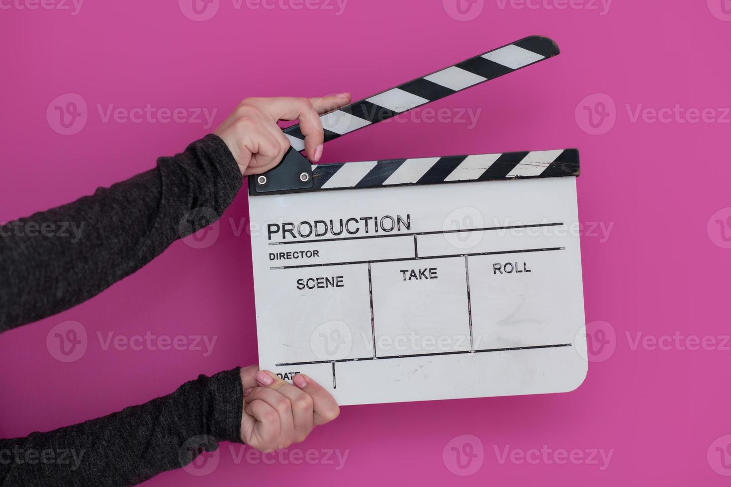 movie clapper on pink background photo