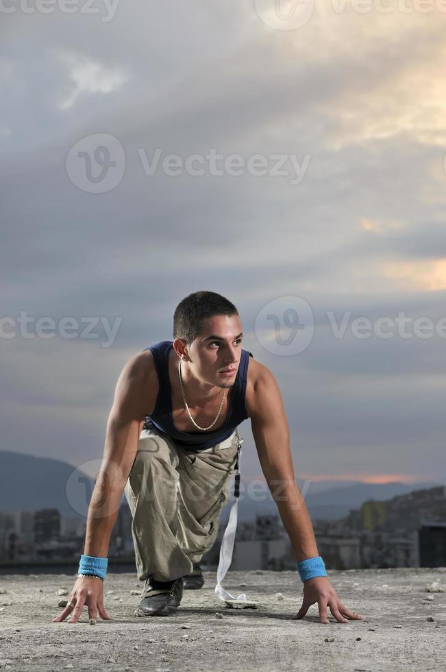 man on the start position ready to run photo