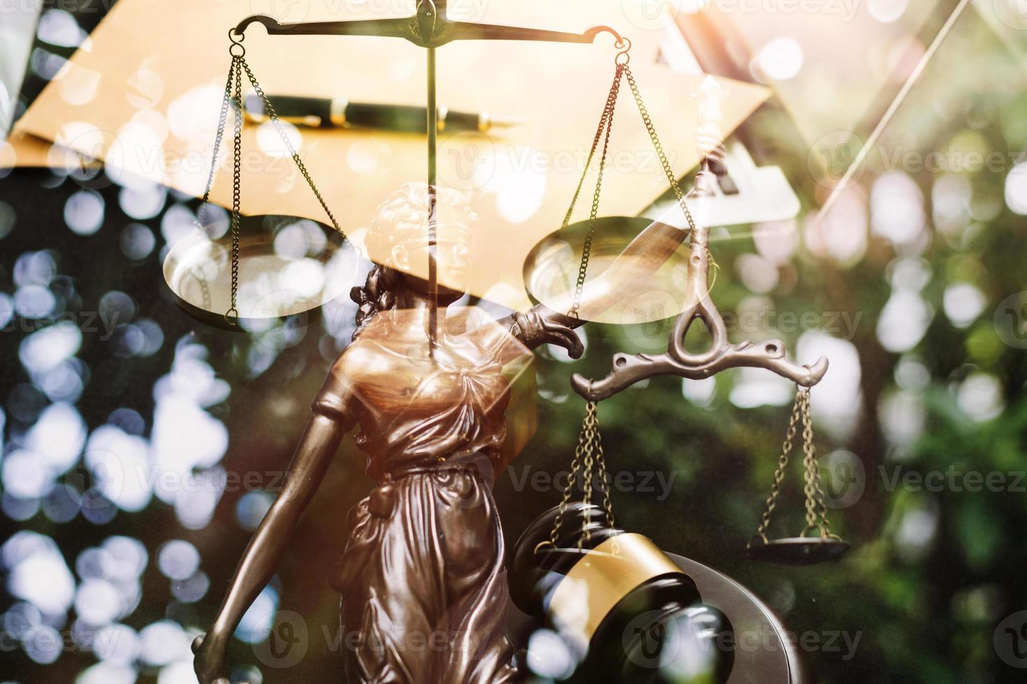 Justice and law concept.Male judge in a courtroom with the gavel, working with, computer and docking keyboard, eyeglasses, on table in morning light photo