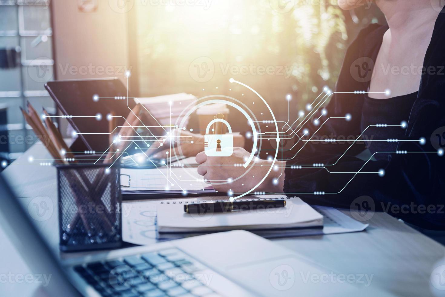 Cybersecurity and privacy concepts to protect data. Lock icon and internet network security technology. Businessman protecting personal data on smart phone with virtual screen interfaces. photo