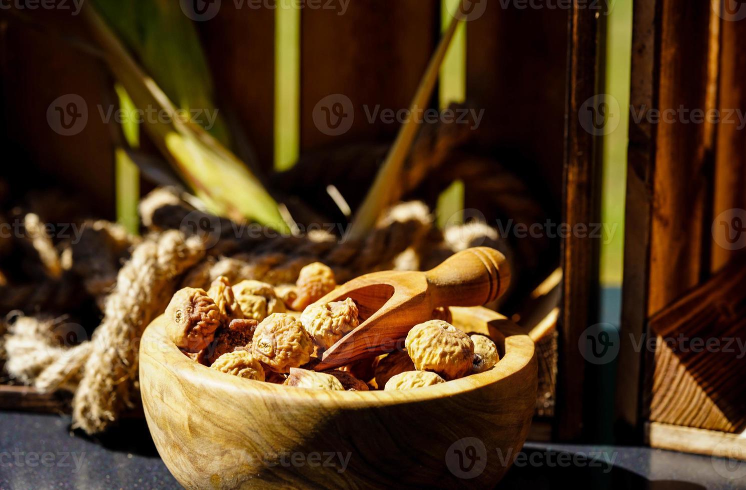 sweet dried figs in an olive wood bowl photo