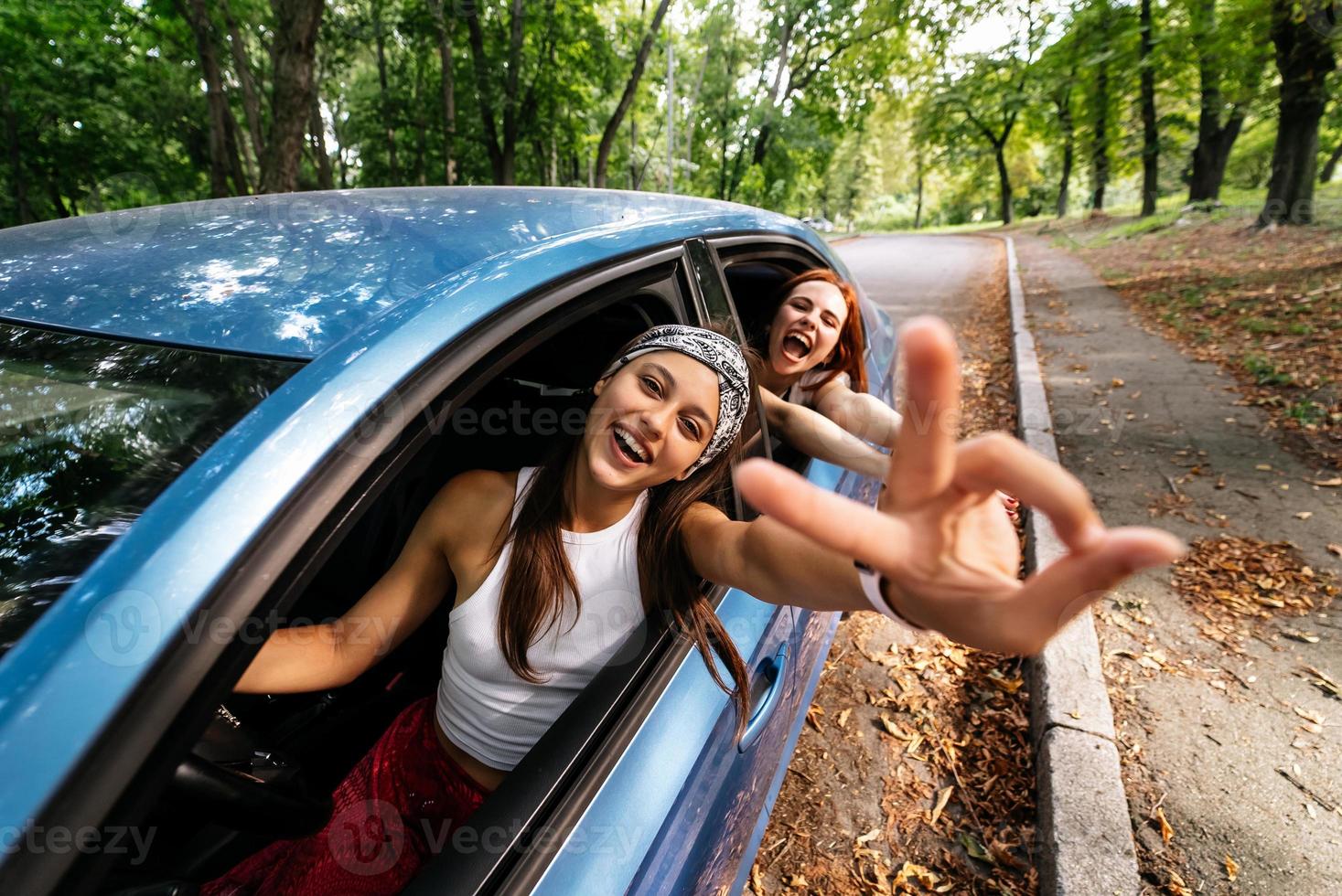 dos amigas se divierten y se ríen juntas en un auto foto