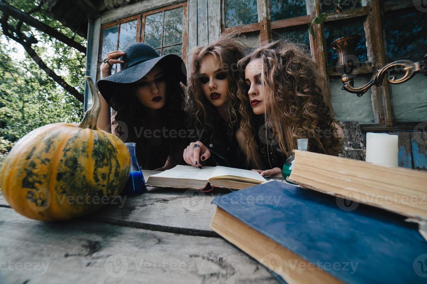 Three vintage witches perform magic ritual photo