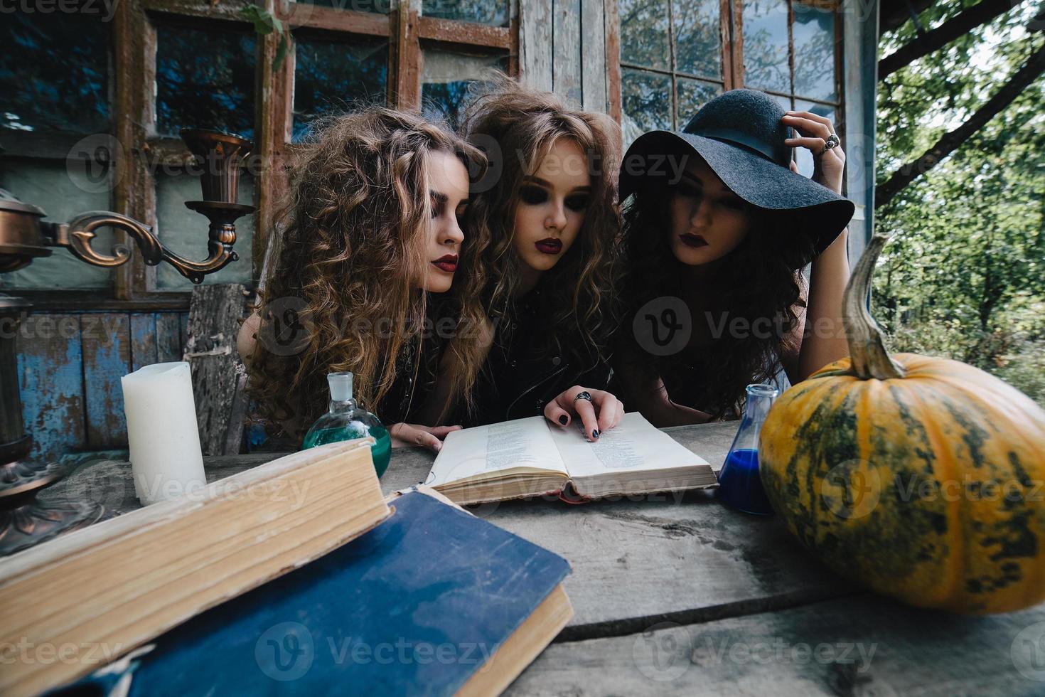 Three vintage witches perform magic ritual photo