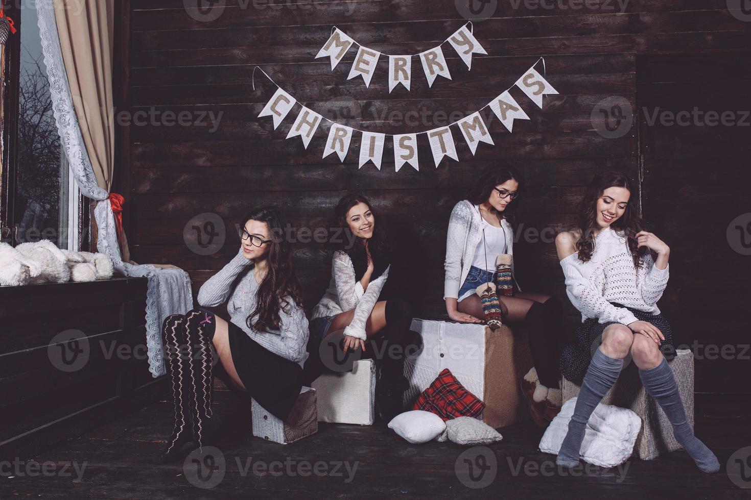 Four charming model posing on a vintage New Year's background photo