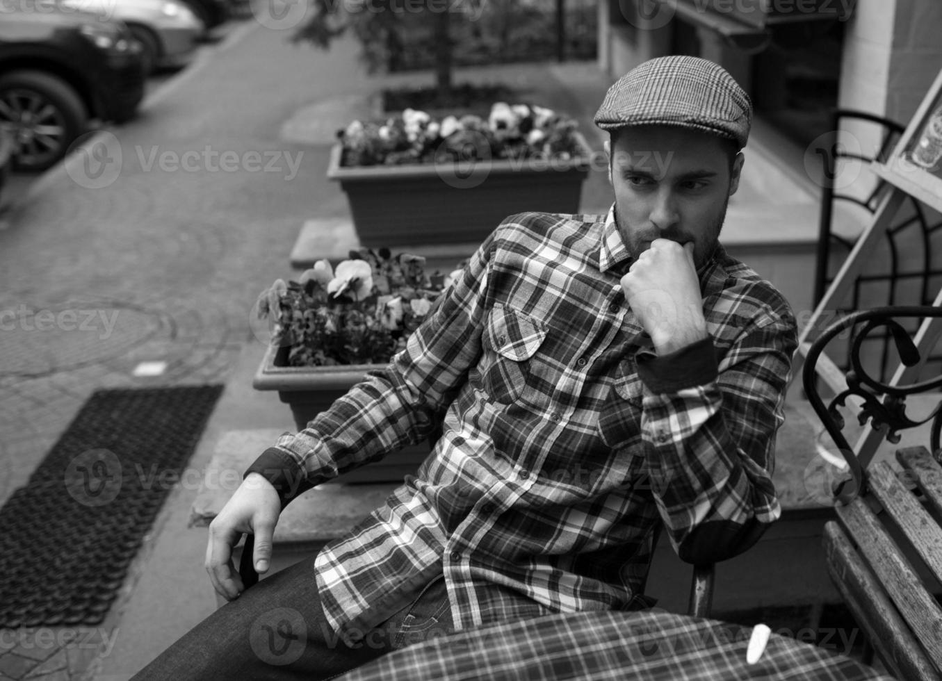 The man in the authentic boots and selvedge jeans  sitting at the table photo