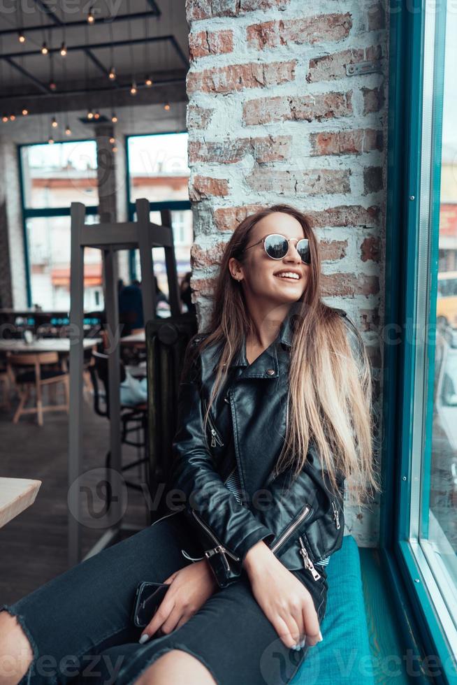 Beautiful girl in sunglasses posing on camera photo