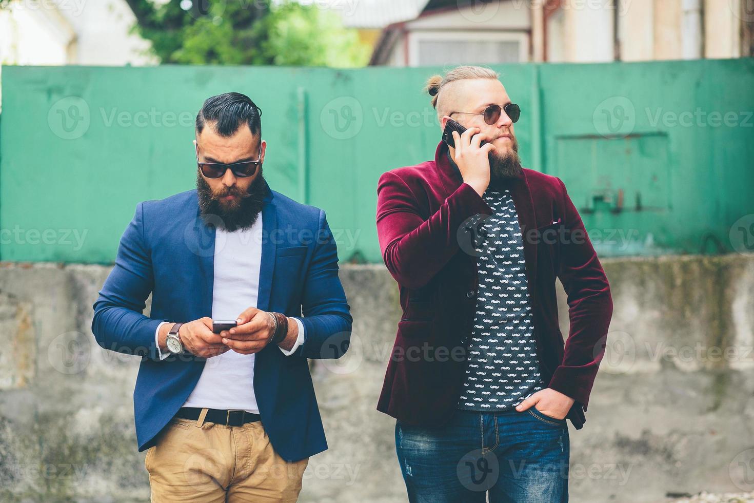 Bearded businessman looking at phone photo