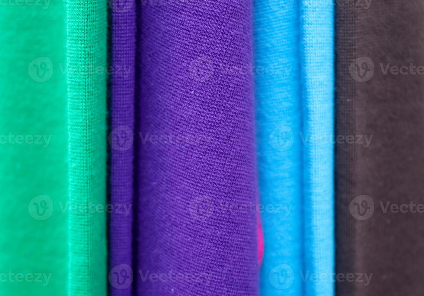 Detailed close up view on samples of cloth and fabrics in different colors found at a fabrics market photo