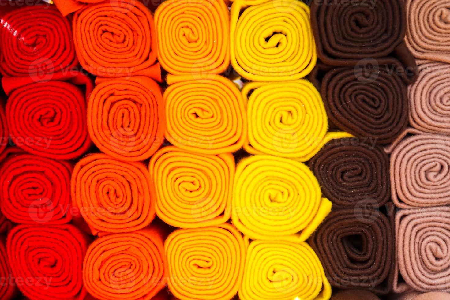 Detailed close up view on samples of cloth and fabrics in different colors found at a fabrics market photo