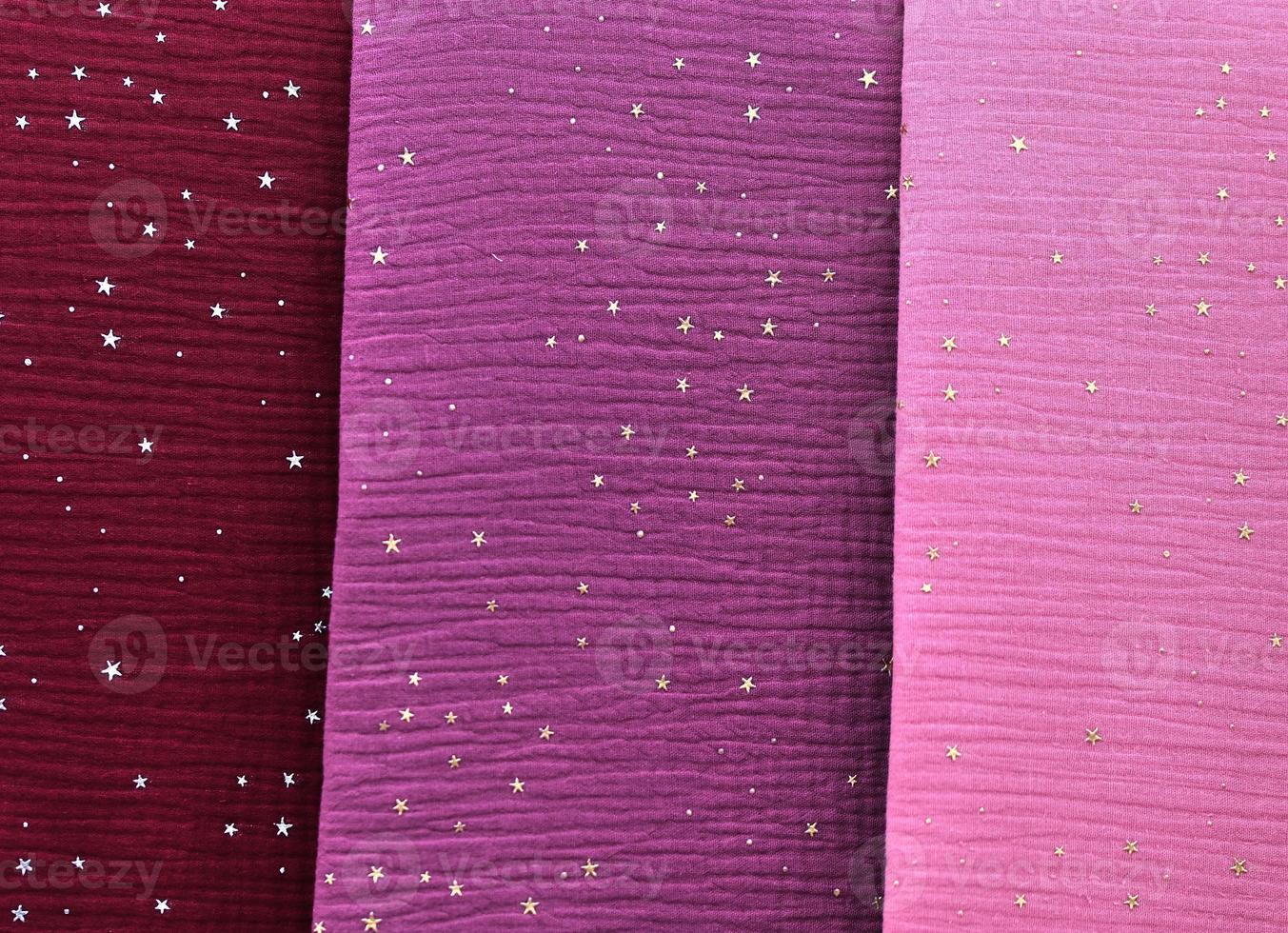 Detailed close up view on samples of cloth and fabrics in different colors found at a fabrics market photo