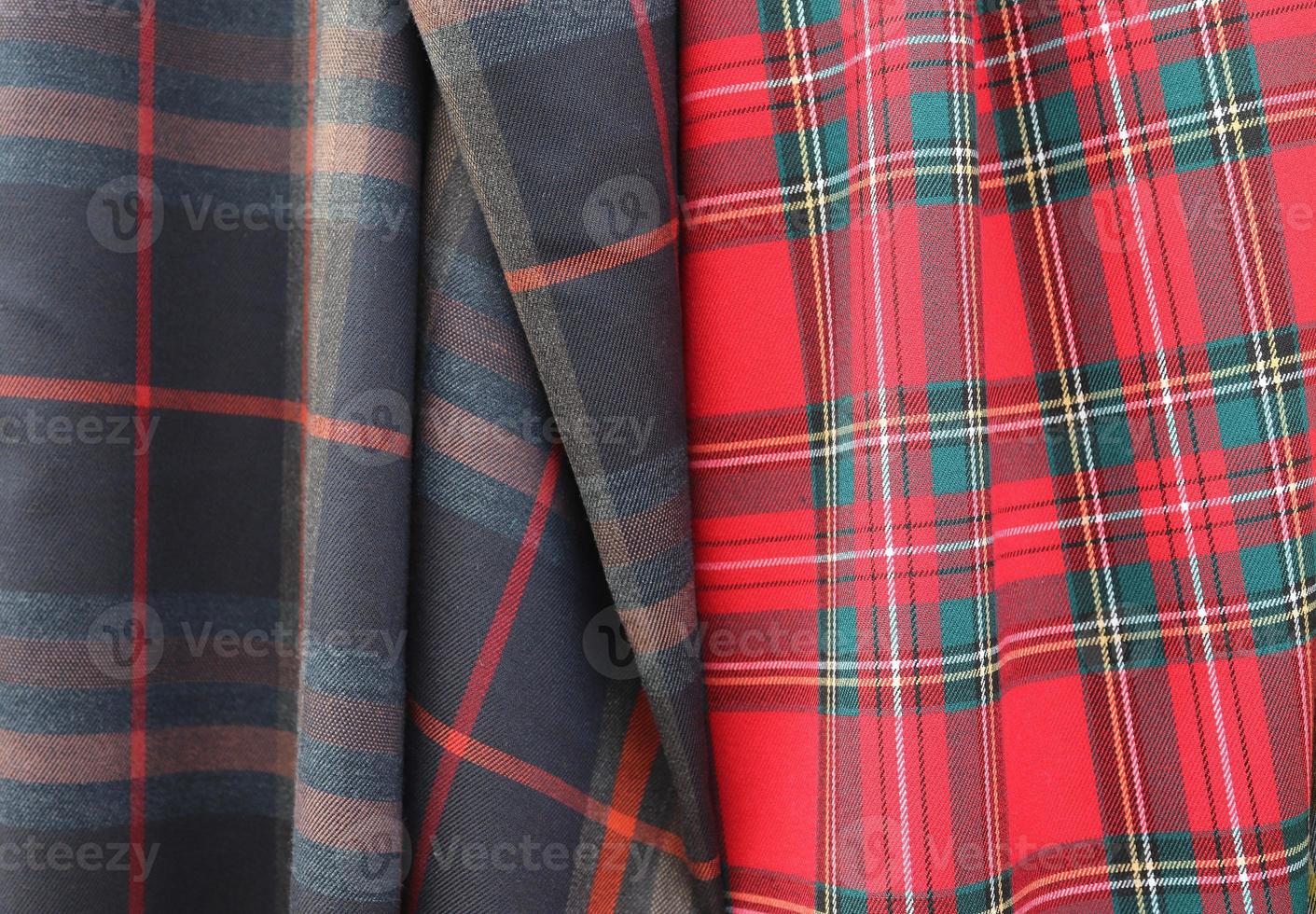 Detailed close up view on samples of cloth and fabrics in different colors found at a fabrics market photo