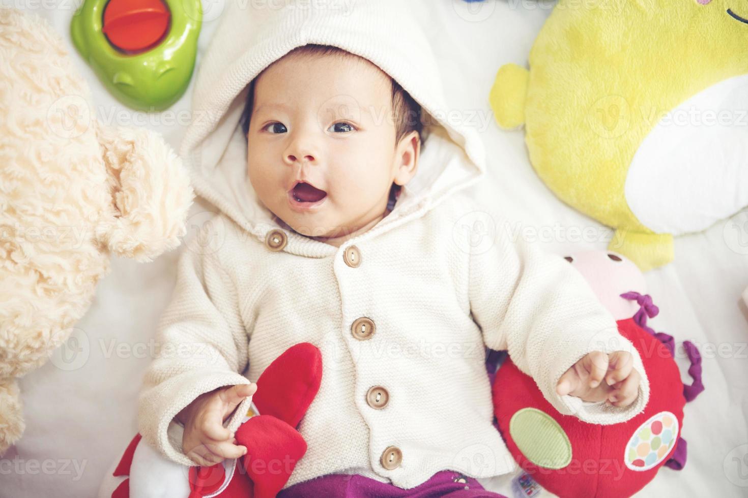 Baby with toy and doll photo