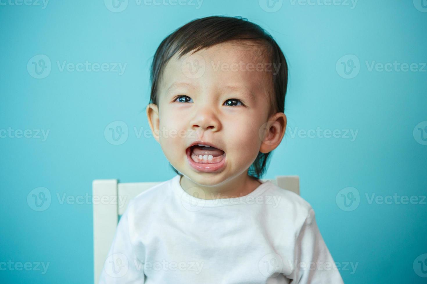 Asian baby girl crying, studio shot photo