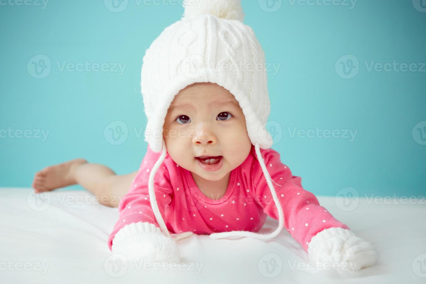 Newborn child in pink  polka dot clothing photo