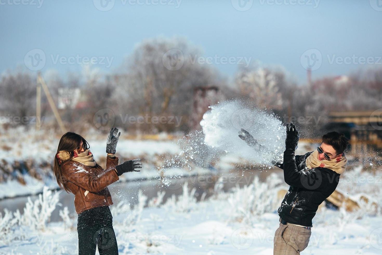 Young couple having fun in winter park photo