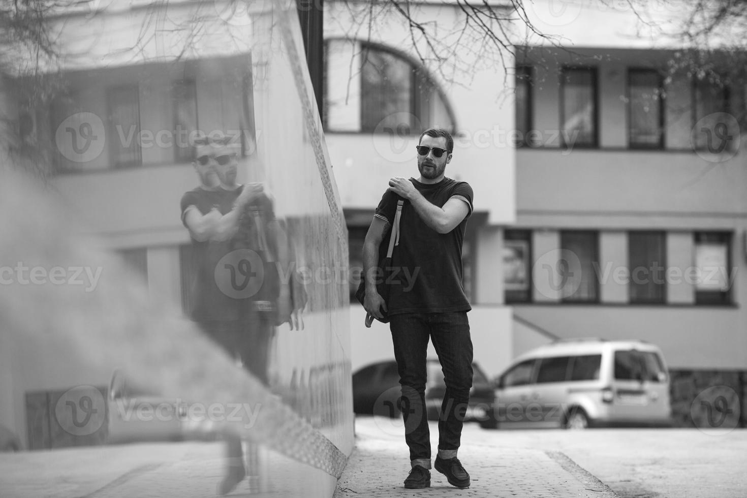 The man in the authentic boots and selvedge jeans  on a background of old city photo