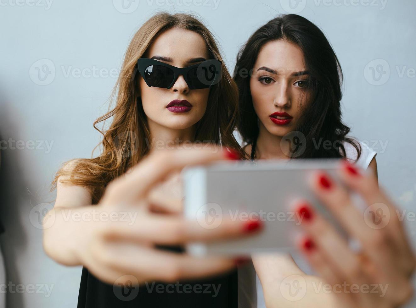 Two girlfriends taking a selfie photo