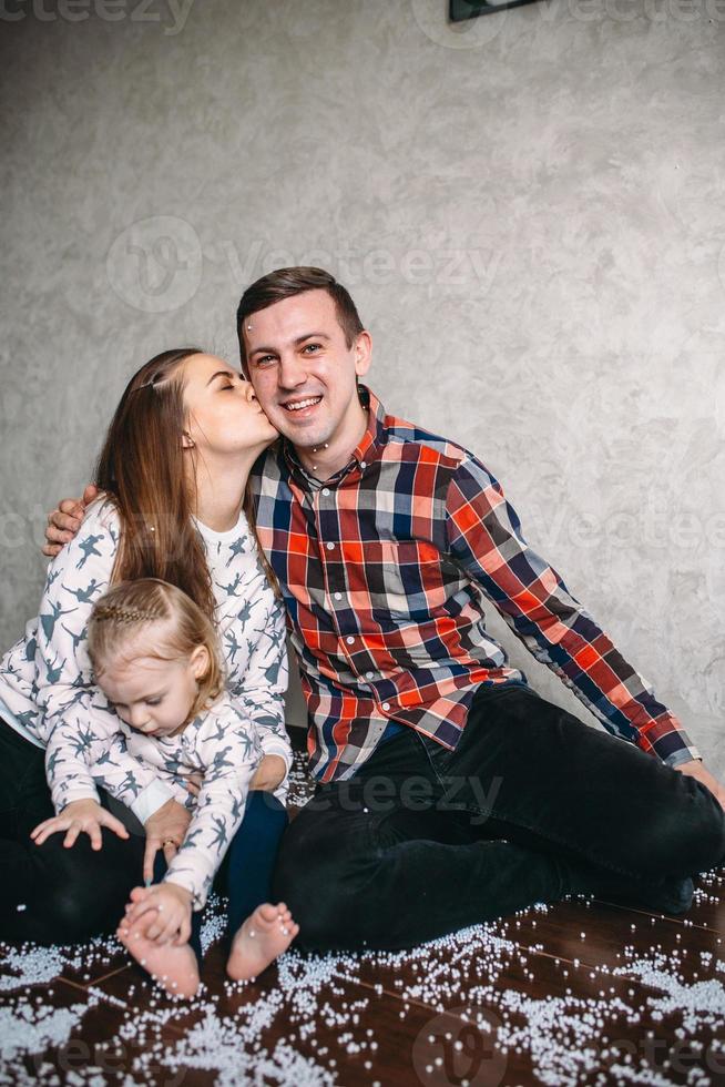 Happy family playing together on the floor photo