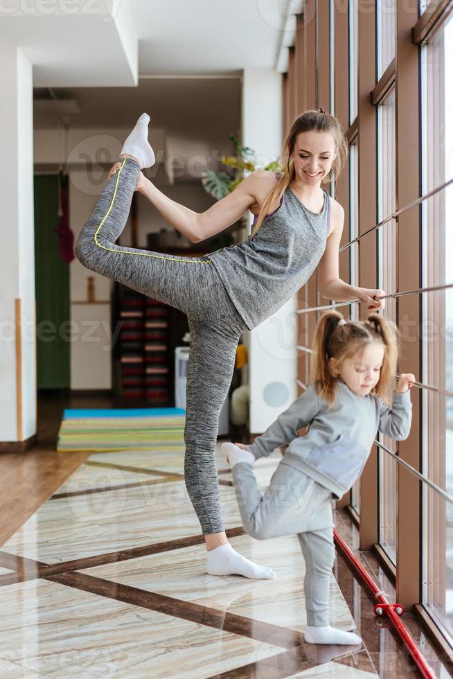 mamá e hija juntas realizan diferentes ejercicios foto