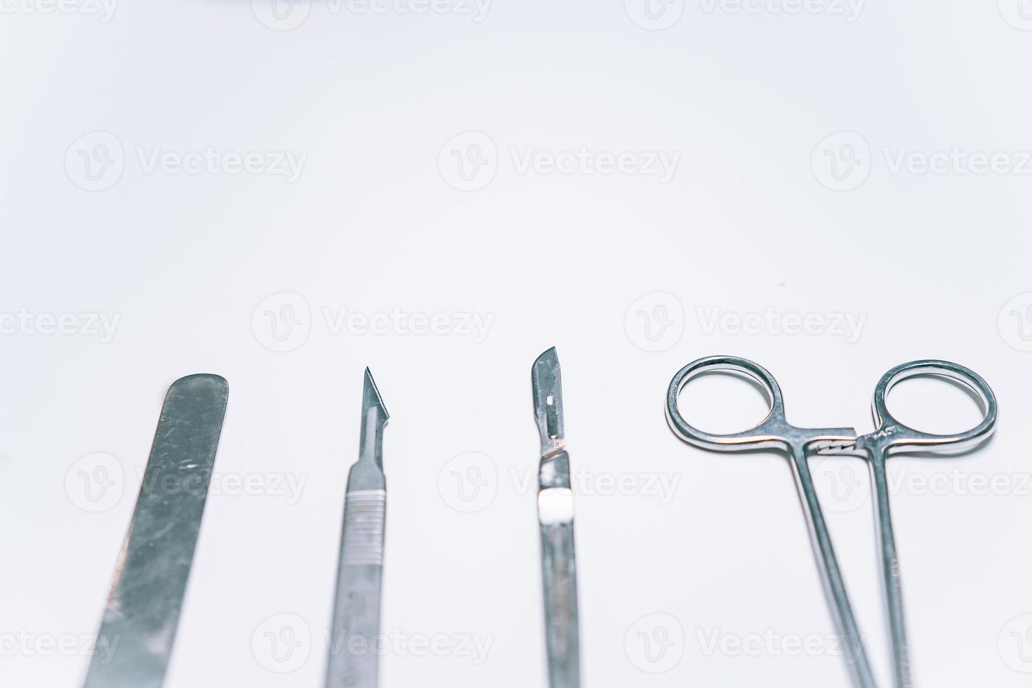 Scapula for throat, two scalpels and clamp on a light background photo