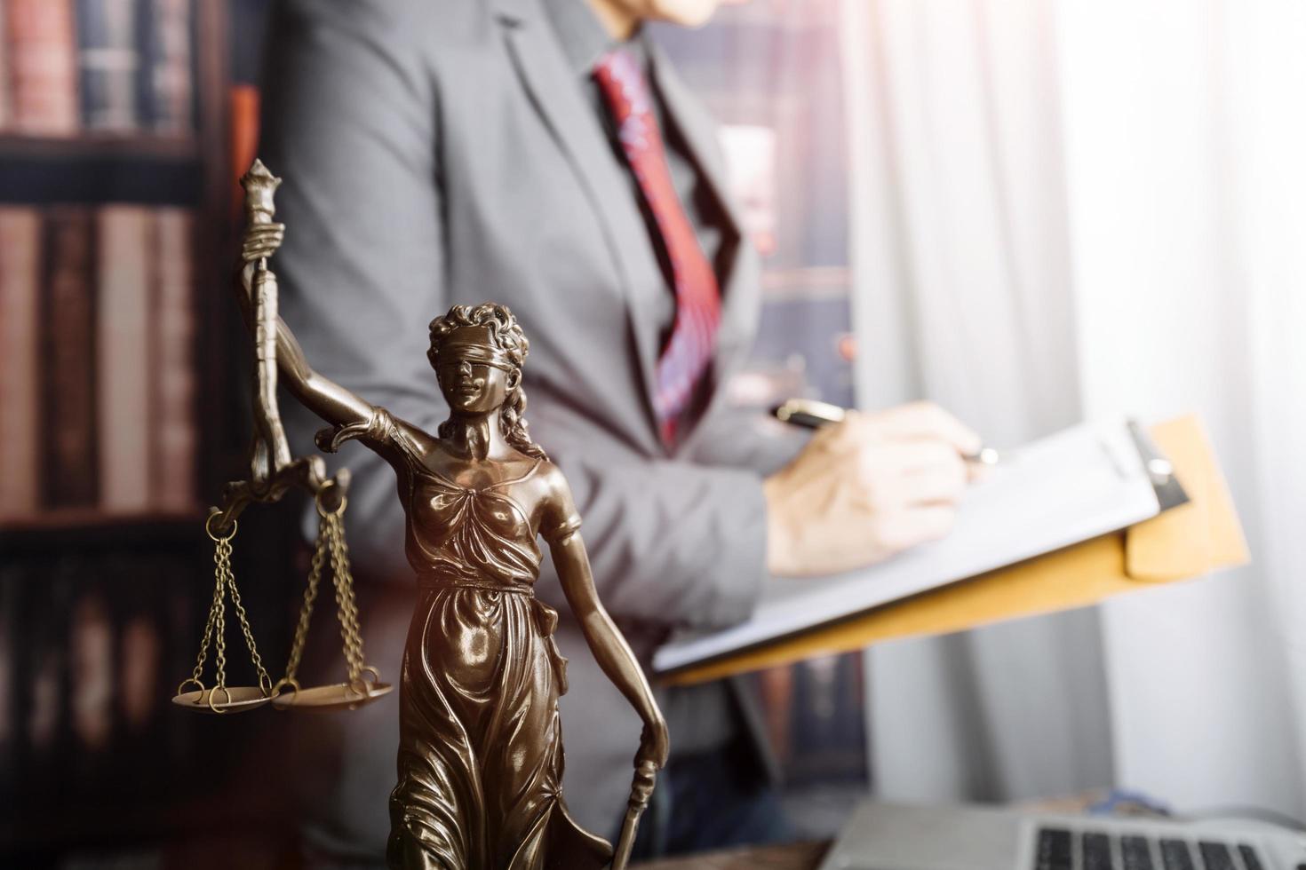 Business and lawyers discussing contract papers with brass scale on desk in office. Law, legal services, advice, justice and law concept picture with film grain effect photo