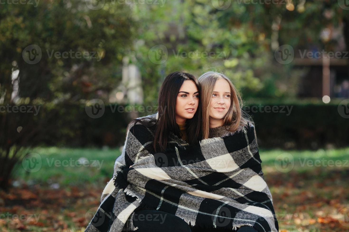 two beautiful in the park, posing for the camera photo