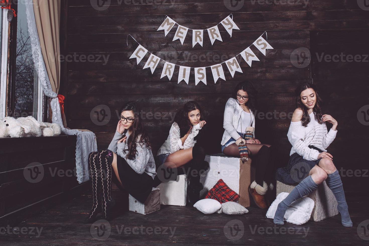 Four charming model posing on a vintage New Year's background photo
