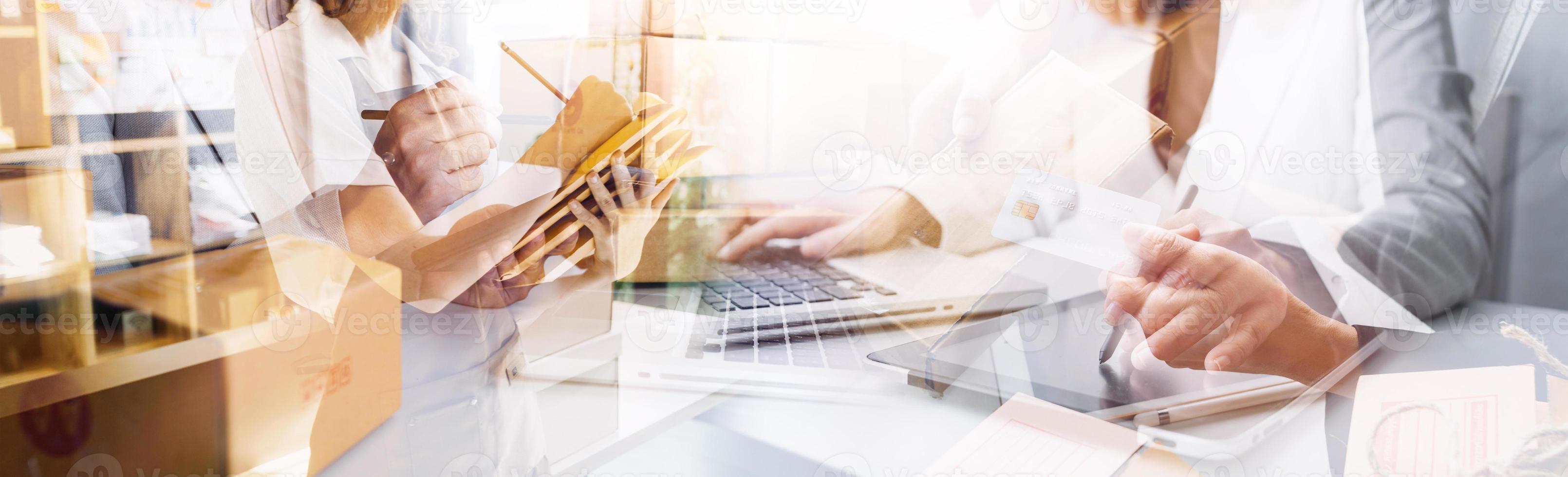 Startup small business entrepreneur or freelance Asian woman using a laptop with box, Young success Asian woman with her hand lift up, online marketing packaging box and delivery, SME concept. photo