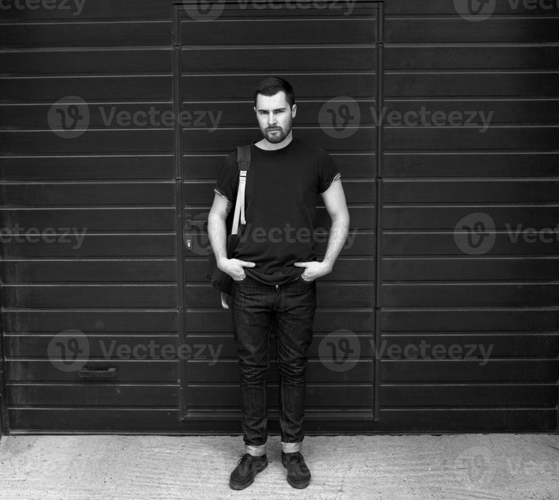 The man in the authentic boots and selvedge jeans  on a background of old city photo