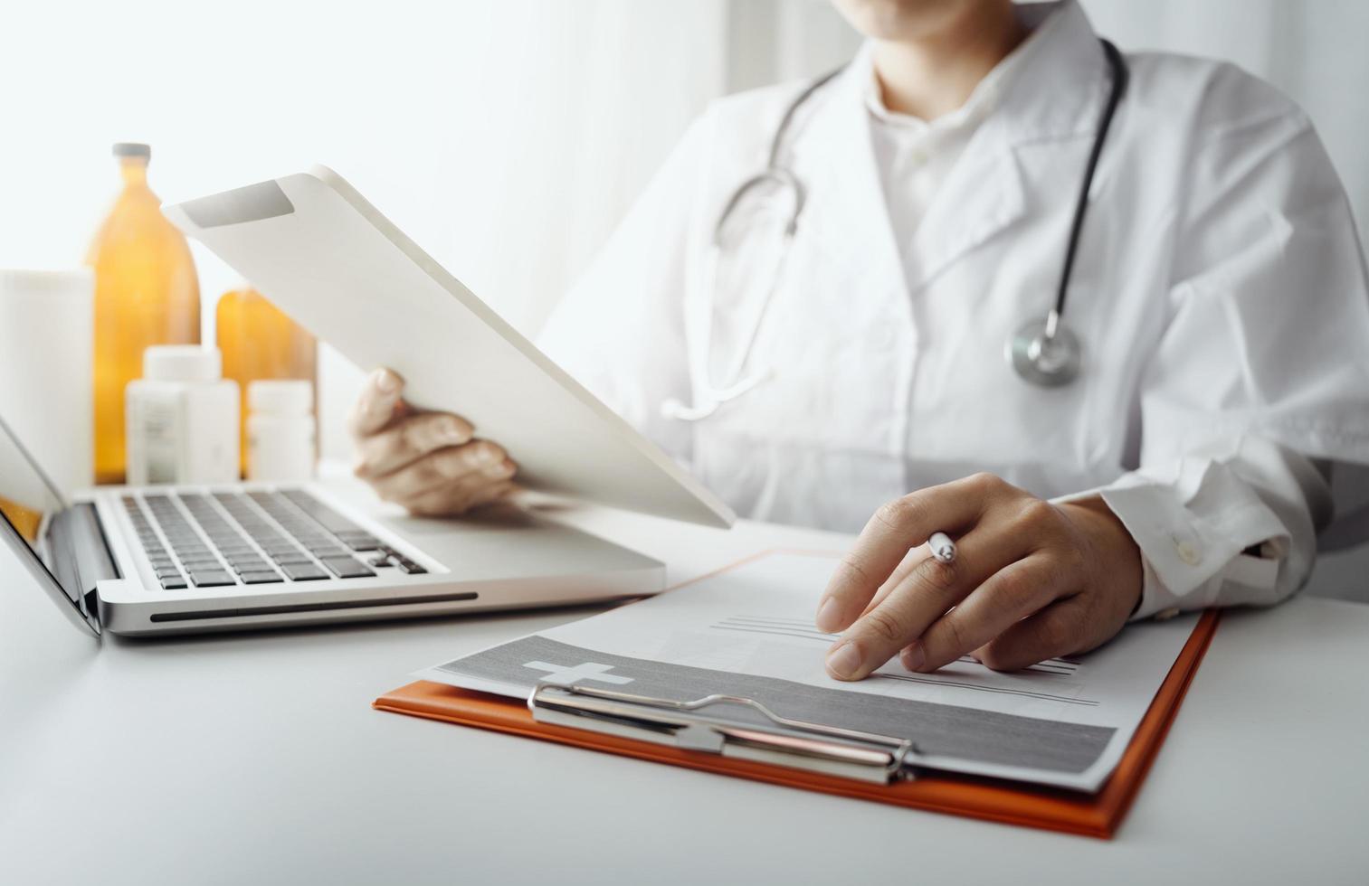 Medicine doctor and stethoscope touching icon medical network connection with modern interface on digital tablet in hospital background. Medical technology network concept photo