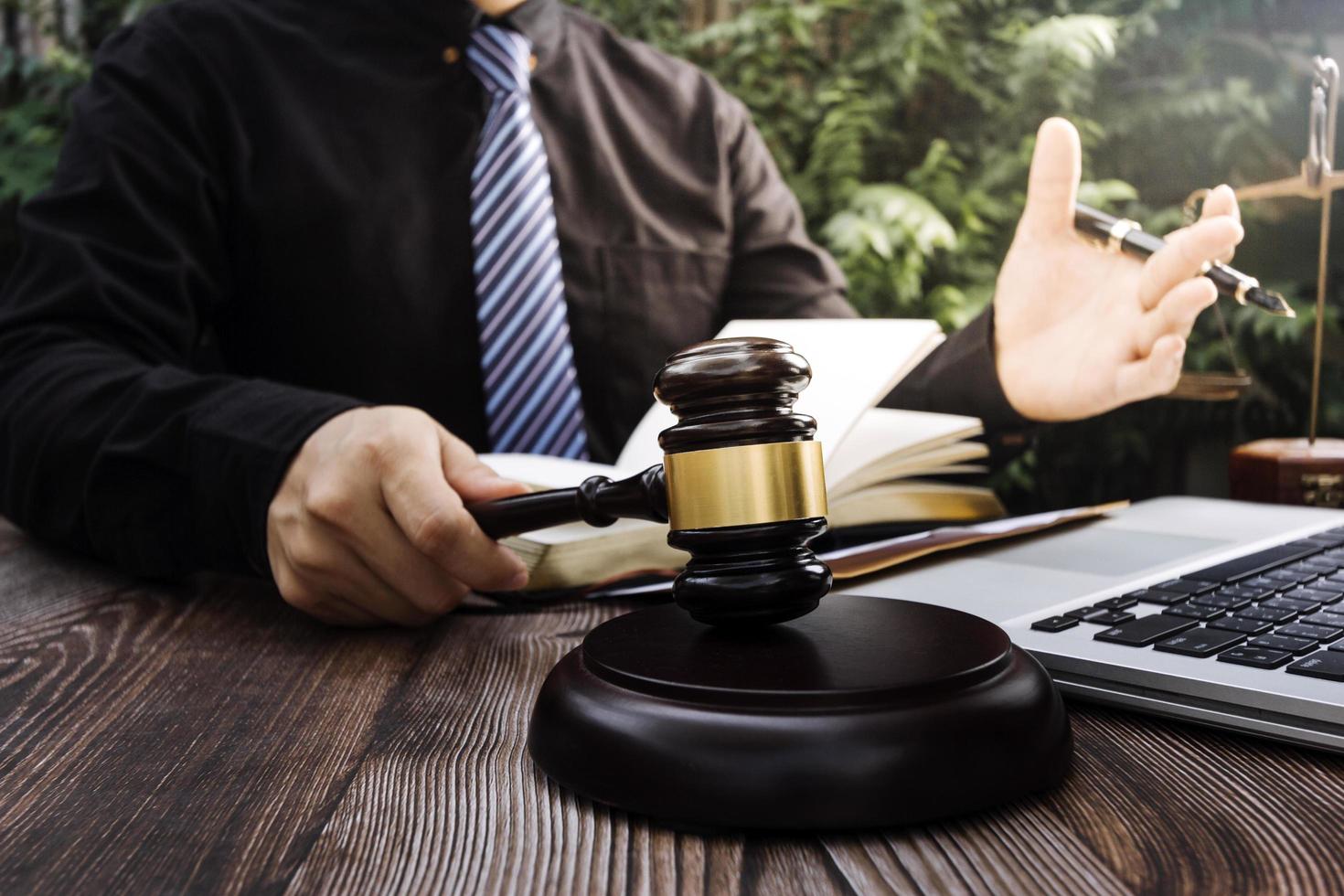 Business and lawyers discussing contract papers with brass scale on desk in office. Law, legal services, advice, justice and law concept picture with film grain effect photo