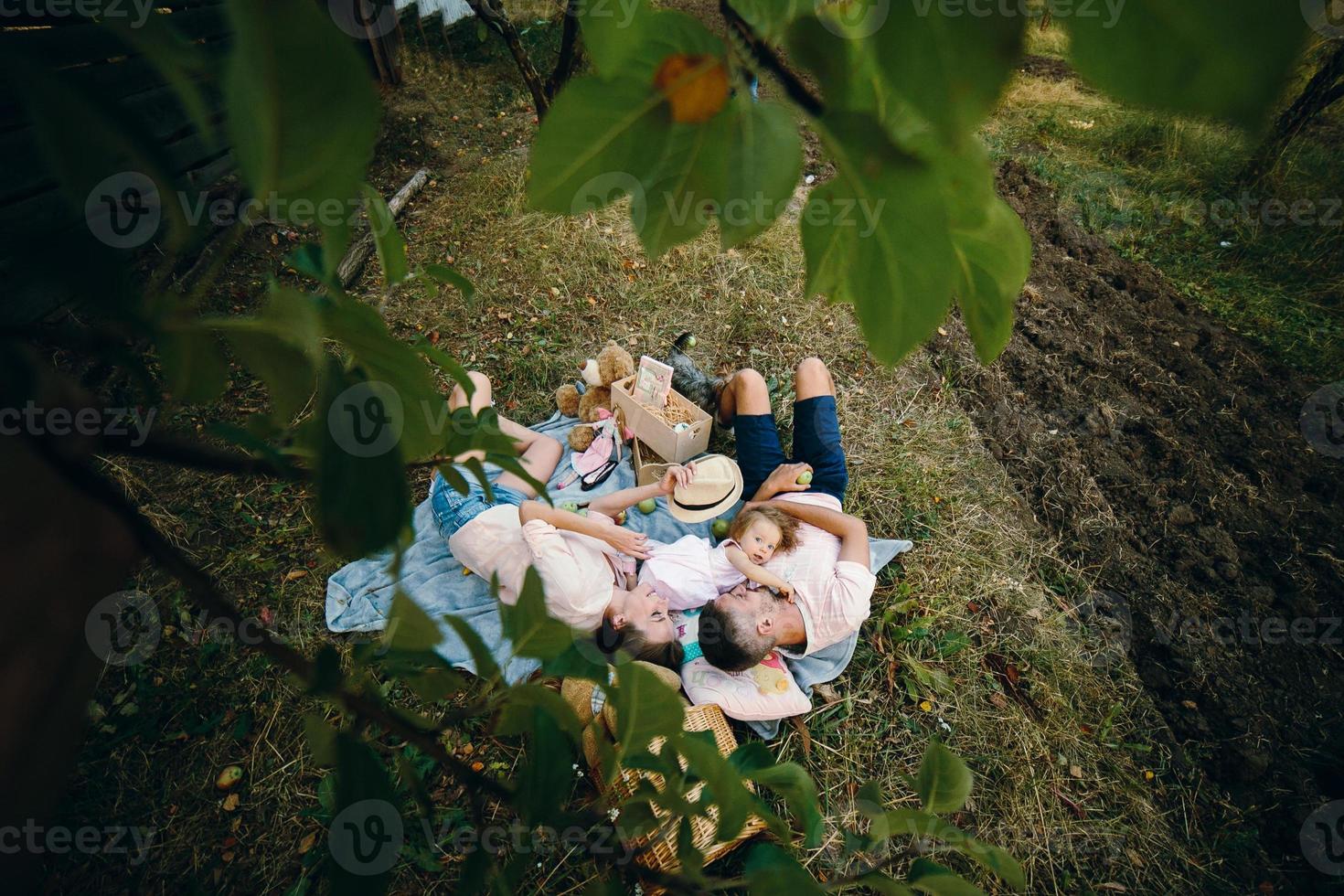 Happy family on lawn in the park photo