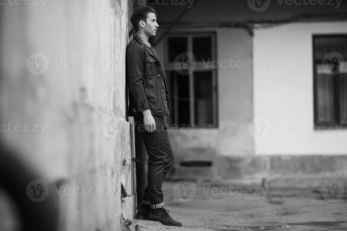 man in jeans on the background of a  wall photo